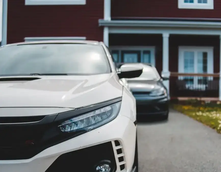 Close-up of a luxury sports car parked in front of a suburban house on a quiet street.